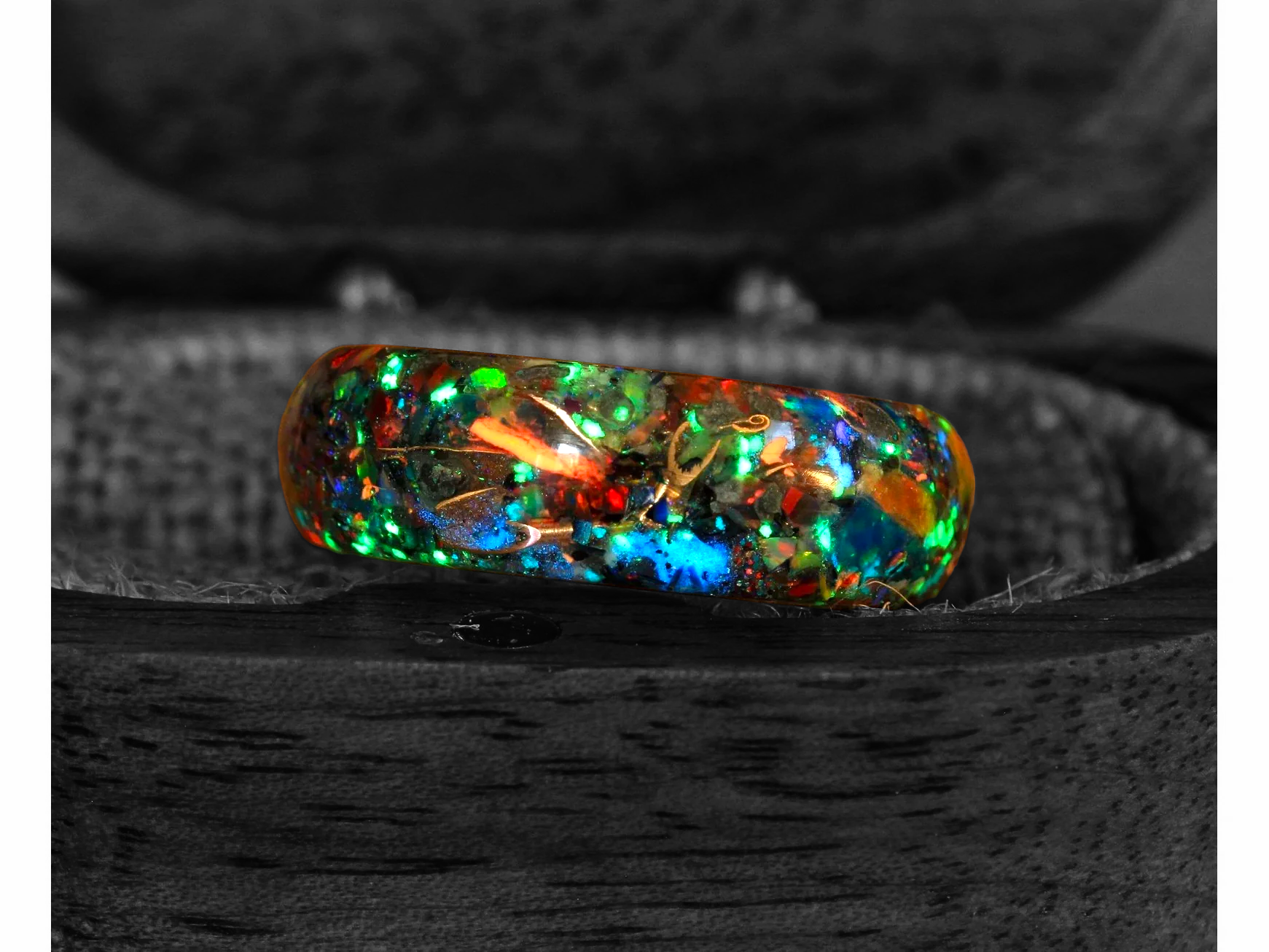 A multicolored and iridescent crystal ring featuring a striking meteorite slice, Neon Apatite, Moldavite, Rainbow Moonstone, White Fire Opal, and Peacock Ore, encapsulating the wonders of the universe. Bespoke Space, Edgeless Crystal Meteorite Rings.